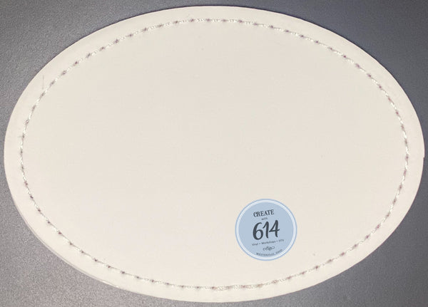 An oval-shaped, 3x2 inch, adhesive leatherette patch with a sublimation print design suitable for customizing bags, jackets, and other items.